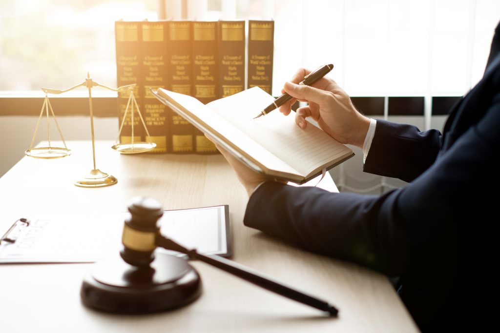 the lawyers sitting in their office is meticulously examining the judicial documents to gather crucial information and build a strong legal strategy for their client's case.